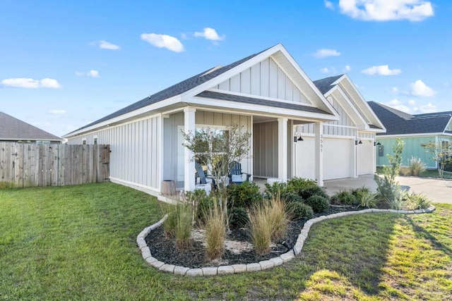 view of front of property featuring a front lawn and a garage