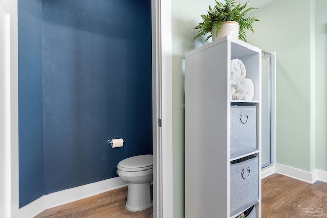 bathroom featuring toilet and hardwood / wood-style flooring