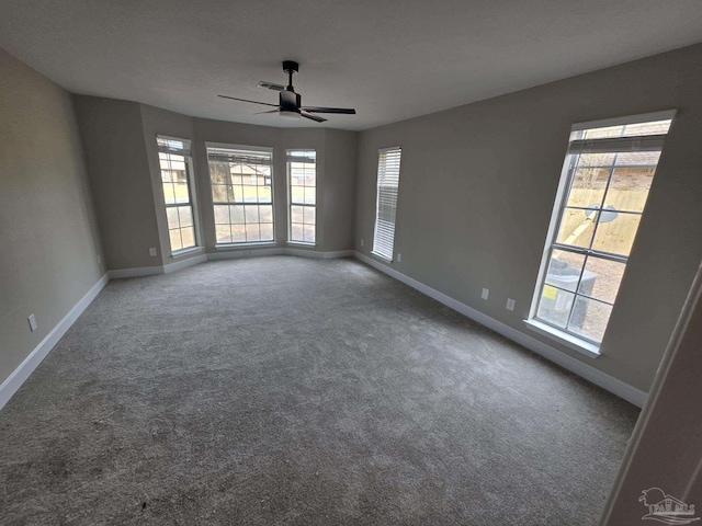 5674 Windsong Dr, Milton, FL 32570 - unfurnished room with baseboards, healthy amount of natural light, carpet floors, and a ceiling fan
