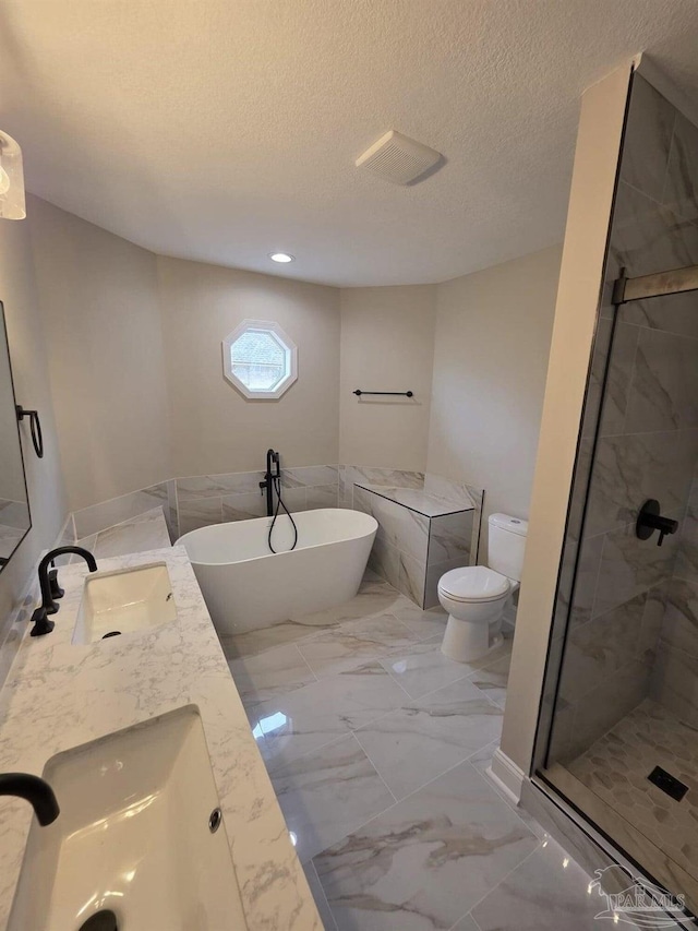 5674 Windsong Dr, Milton, FL 32570 - bathroom featuring marble finish flooring, a freestanding bath, a shower stall, toilet, and a textured ceiling