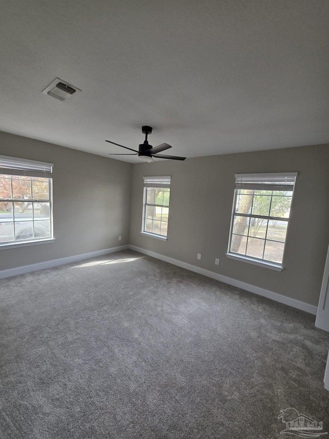 5674 Windsong Dr, Milton, FL 32570 - carpeted spare room with baseboards and a ceiling fan