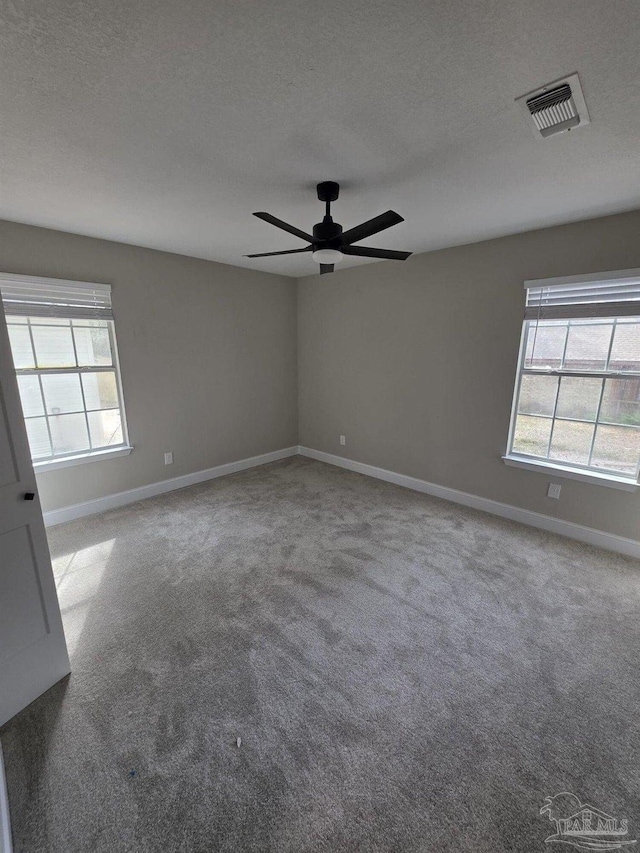 5674 Windsong Dr, Milton, FL 32570 - carpeted empty room featuring baseboards, ceiling fan, and a textured ceiling
