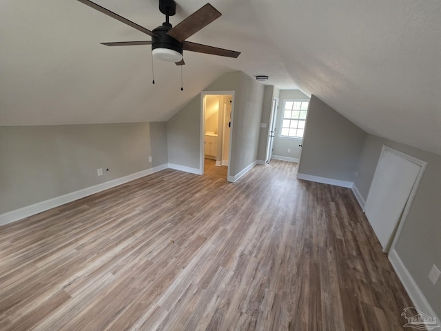 5674 Windsong Dr, Milton, FL 32570 - additional living space with a ceiling fan, wood finished floors, lofted ceiling, and baseboards