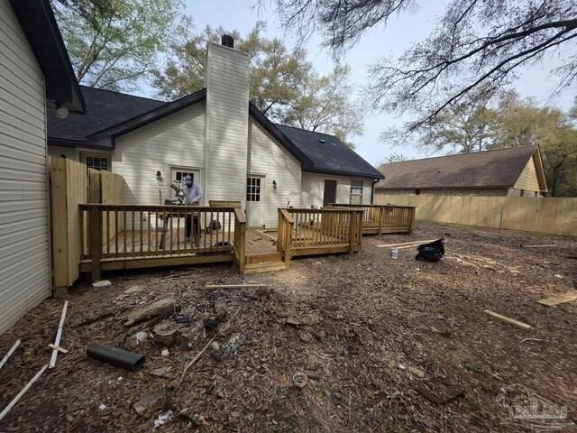 5674 Windsong Dr, Milton, FL 32570 - back of house with a chimney, fence, and a wooden deck