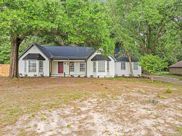 5674 Windsong Dr, Milton, FL 32570 - ranch-style house with fence and roof with shingles