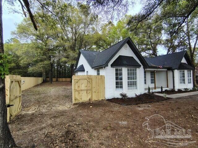 5674 Windsong Dr, Milton, FL 32570 - view of property exterior with fence and a gate