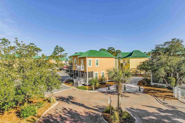 view of front of property featuring cooling unit and a balcony