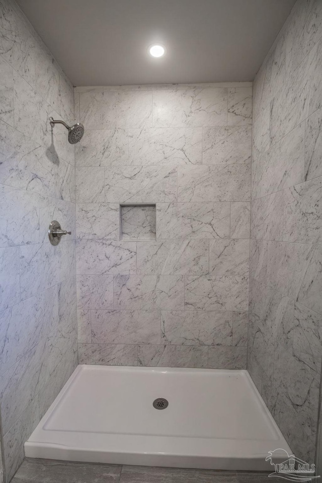 bathroom with tiled shower