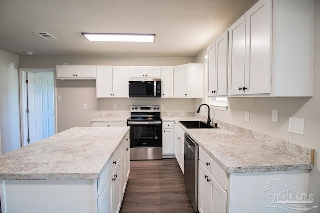 kitchen with white cabinets, appliances with stainless steel finishes, and sink