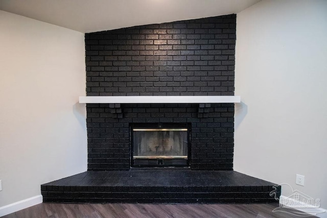 details with a fireplace and wood-type flooring