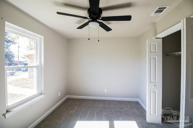 unfurnished bedroom with carpet flooring, ceiling fan, and a closet