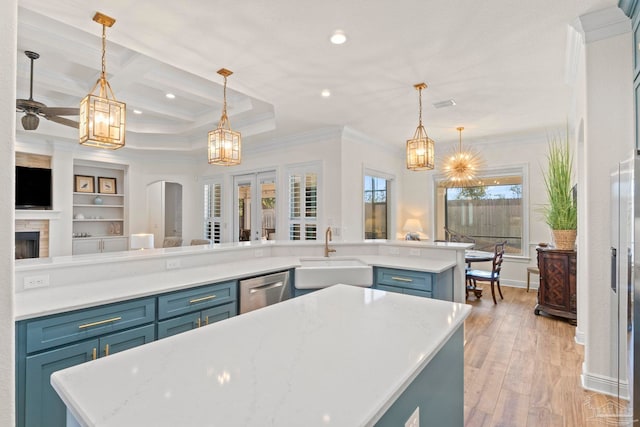 kitchen featuring light countertops, a sink, and a center island with sink