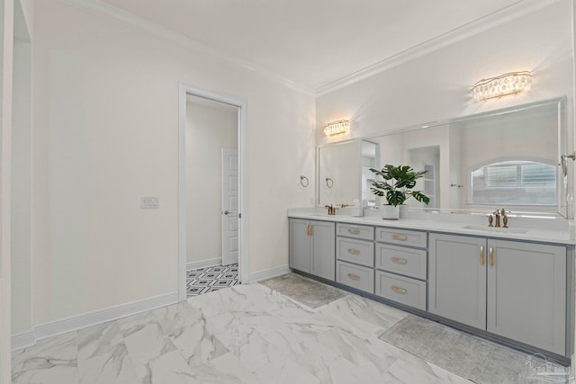 bathroom with double vanity, marble finish floor, a sink, and crown molding