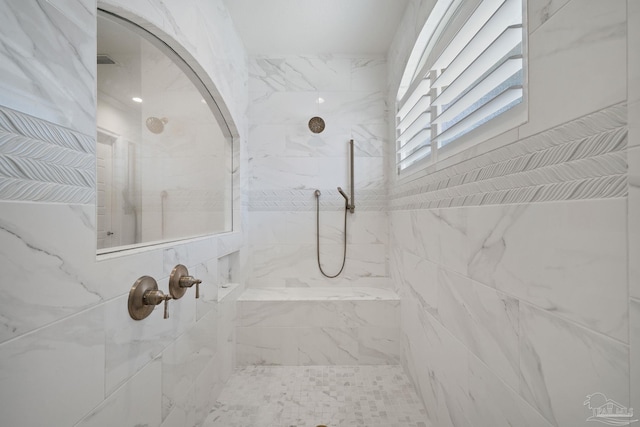 full bathroom with tiled shower