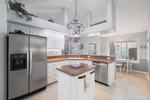 kitchen with white cabinetry, stainless steel appliances, and a kitchen island