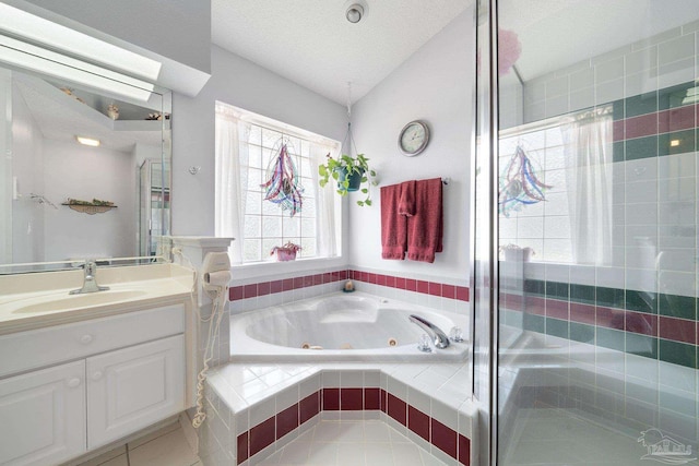 bathroom featuring independent shower and bath, vanity, a textured ceiling, and tile patterned flooring