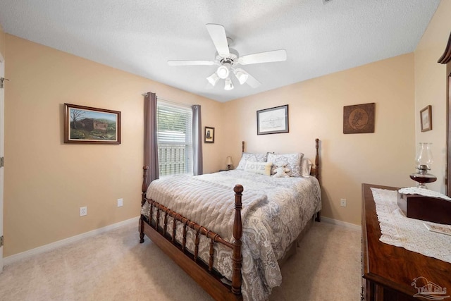 carpeted bedroom with a textured ceiling and ceiling fan