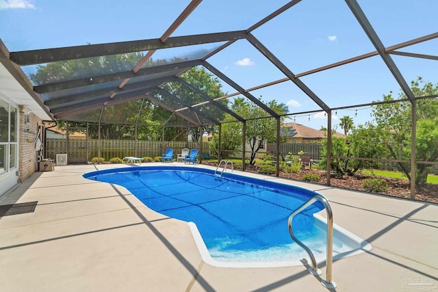 view of pool with a lanai and a patio