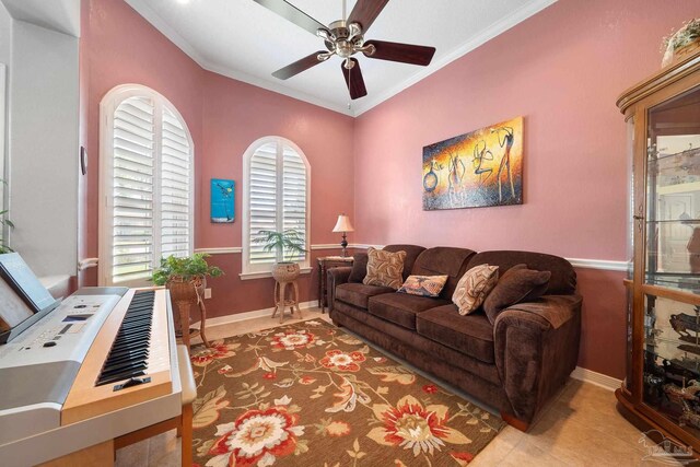 tiled living room with ceiling fan and ornamental molding