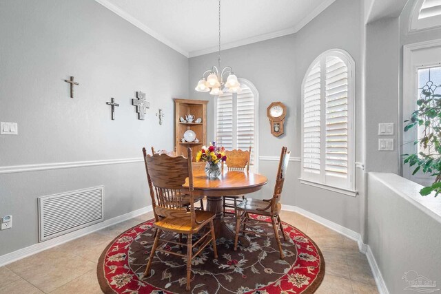 dining space with light tile patterned flooring, a notable chandelier, and crown molding