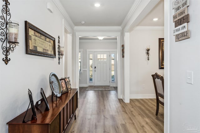 entryway featuring recessed lighting, baseboards, crown molding, and light wood finished floors