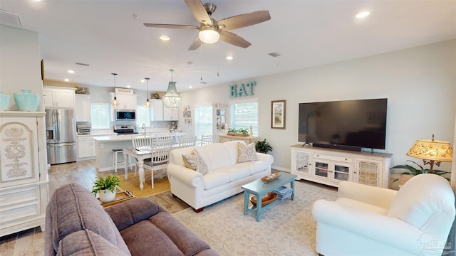 living room featuring ceiling fan and light wood-type flooring