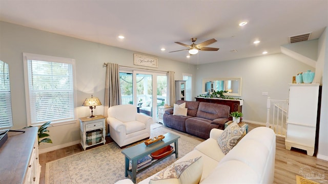 living room with ceiling fan, a healthy amount of sunlight, and light hardwood / wood-style flooring