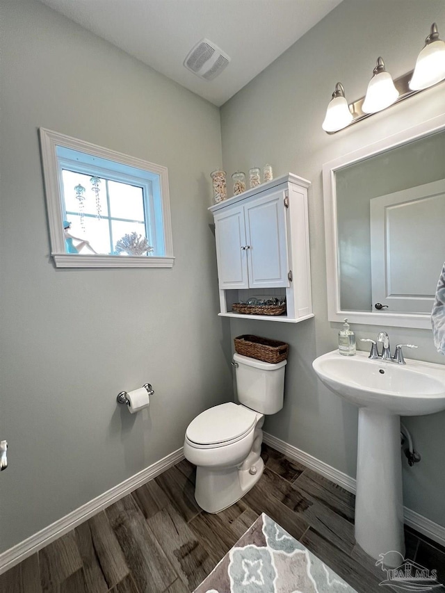 bathroom featuring hardwood / wood-style flooring, sink, and toilet