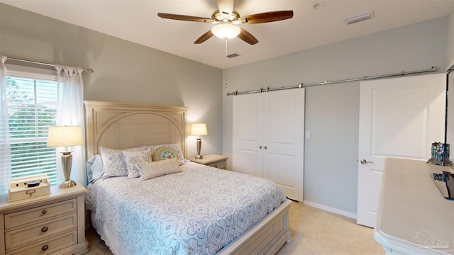 carpeted bedroom with ceiling fan and a closet