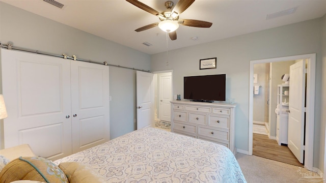 carpeted bedroom featuring ceiling fan and a closet