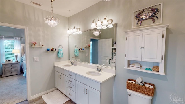 bathroom featuring a chandelier and vanity