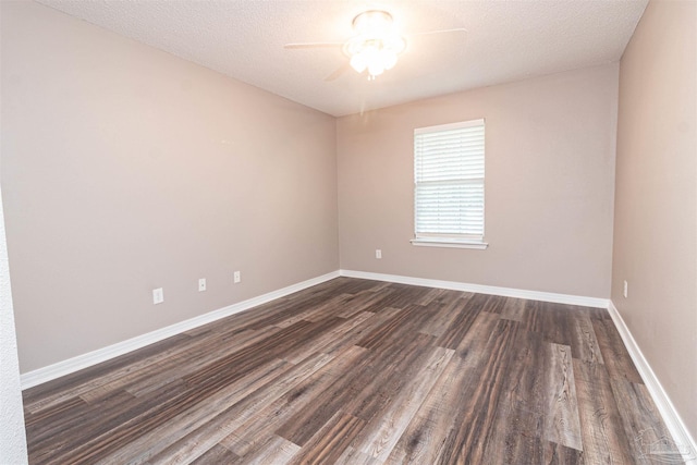 spare room with a ceiling fan, dark wood-style flooring, baseboards, and a textured ceiling