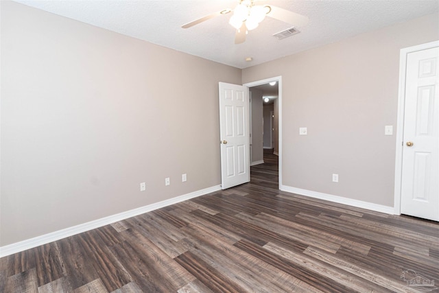 unfurnished bedroom with dark wood-type flooring, baseboards, and a ceiling fan