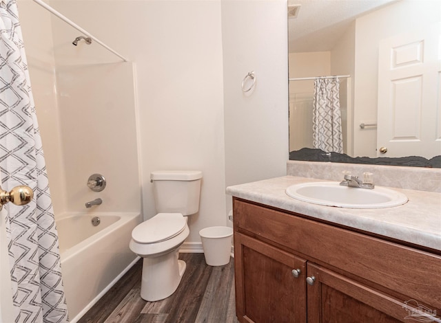 full bathroom featuring wood finished floors, toilet, vanity, and shower / tub combo