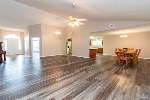 living room with a chandelier, dark wood-style flooring, baseboards, a ceiling fan, and high vaulted ceiling