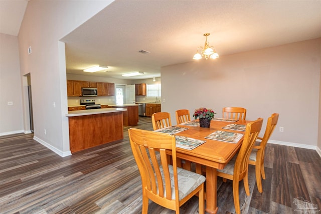 dining room with dark wood-style flooring, baseboards, and a chandelier