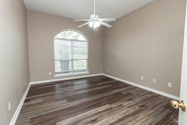 unfurnished room featuring plenty of natural light, ceiling fan, dark wood-type flooring, and baseboards