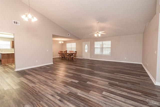 unfurnished living room with a chandelier, dark wood finished floors, ceiling fan, baseboards, and high vaulted ceiling