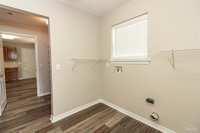 washroom featuring dark wood-style floors, baseboards, washer hookup, and a textured ceiling