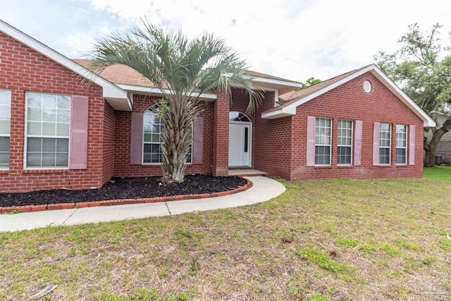single story home with brick siding and a front lawn