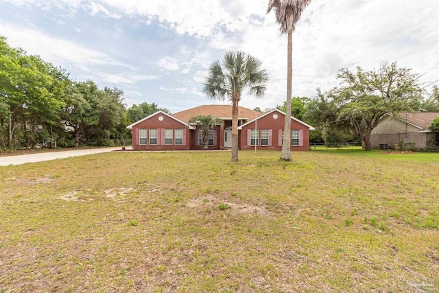 ranch-style home with a front lawn