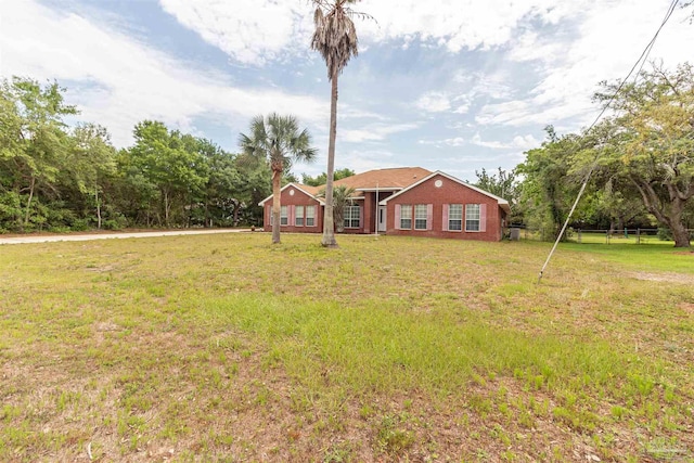 view of front of property featuring a front lawn and brick siding