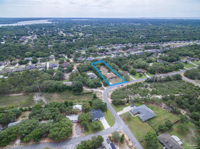 aerial view of property and surrounding area featuring property parcel outlined and nearby suburban area