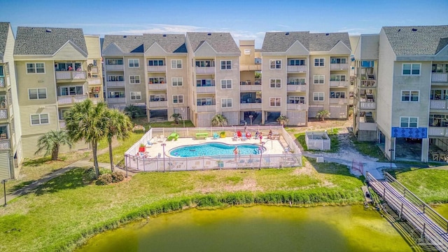 exterior space featuring a community pool and a water view