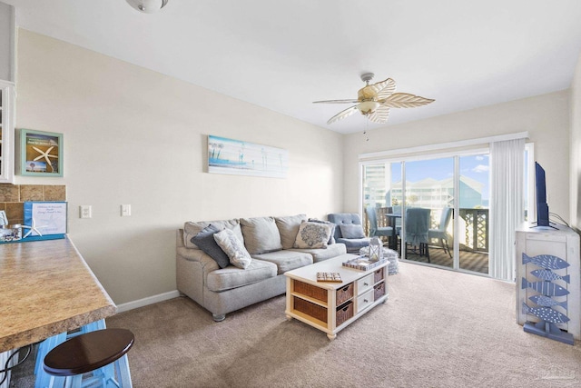 carpeted living room featuring ceiling fan