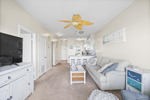 living room with light carpet and ceiling fan