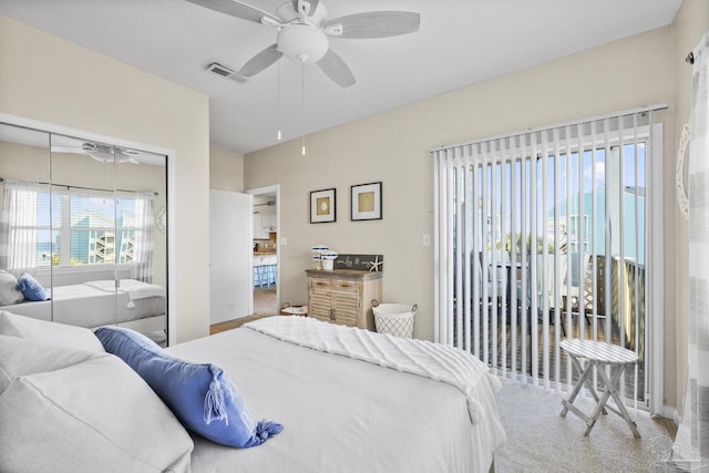 carpeted bedroom featuring a closet and ceiling fan