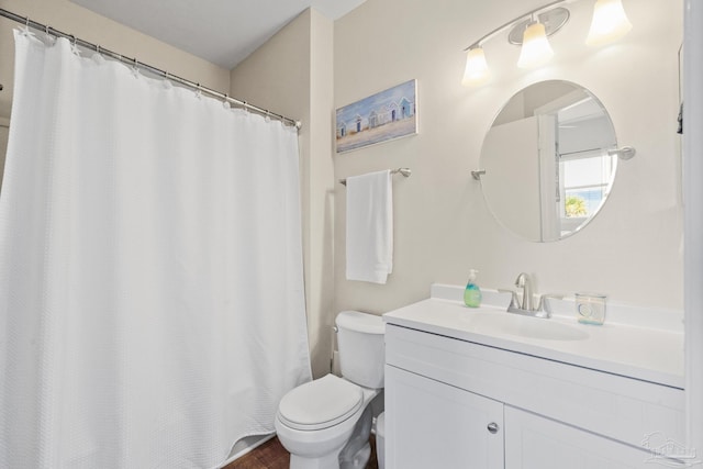 bathroom featuring walk in shower, vanity, and toilet