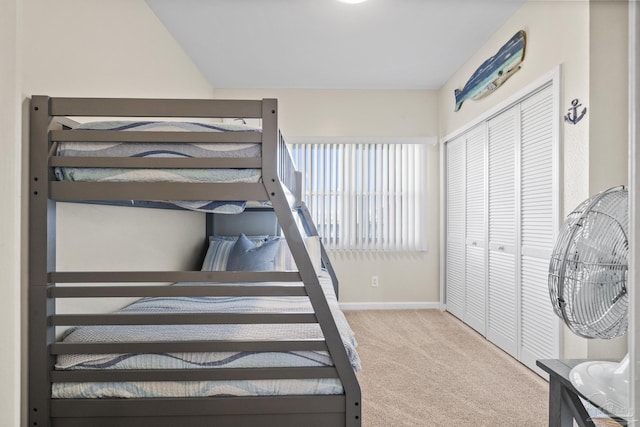 bedroom with a closet and light colored carpet