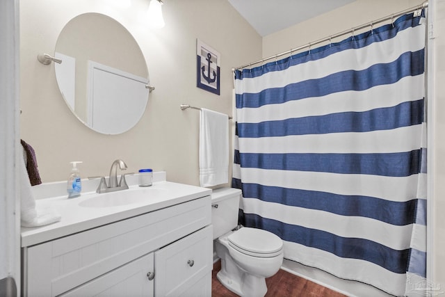 bathroom featuring a shower with curtain, vanity, hardwood / wood-style flooring, and toilet